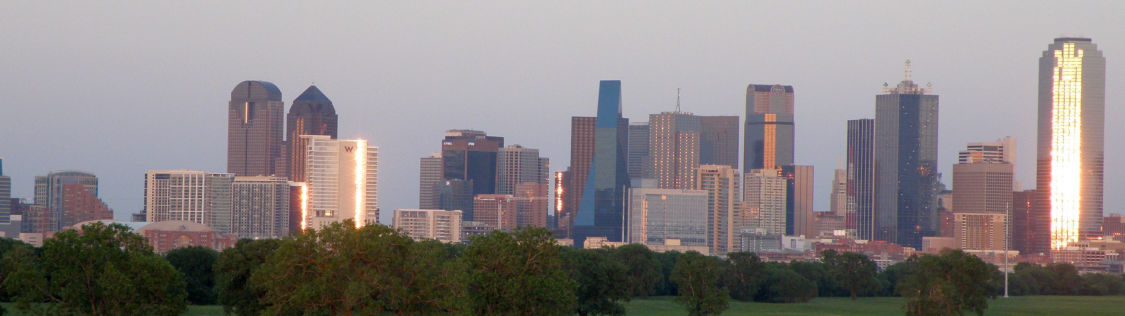 A portion of the Downtown Dallas skyline as seen from the Trinity River Greenbelt Park at sunset.jpg