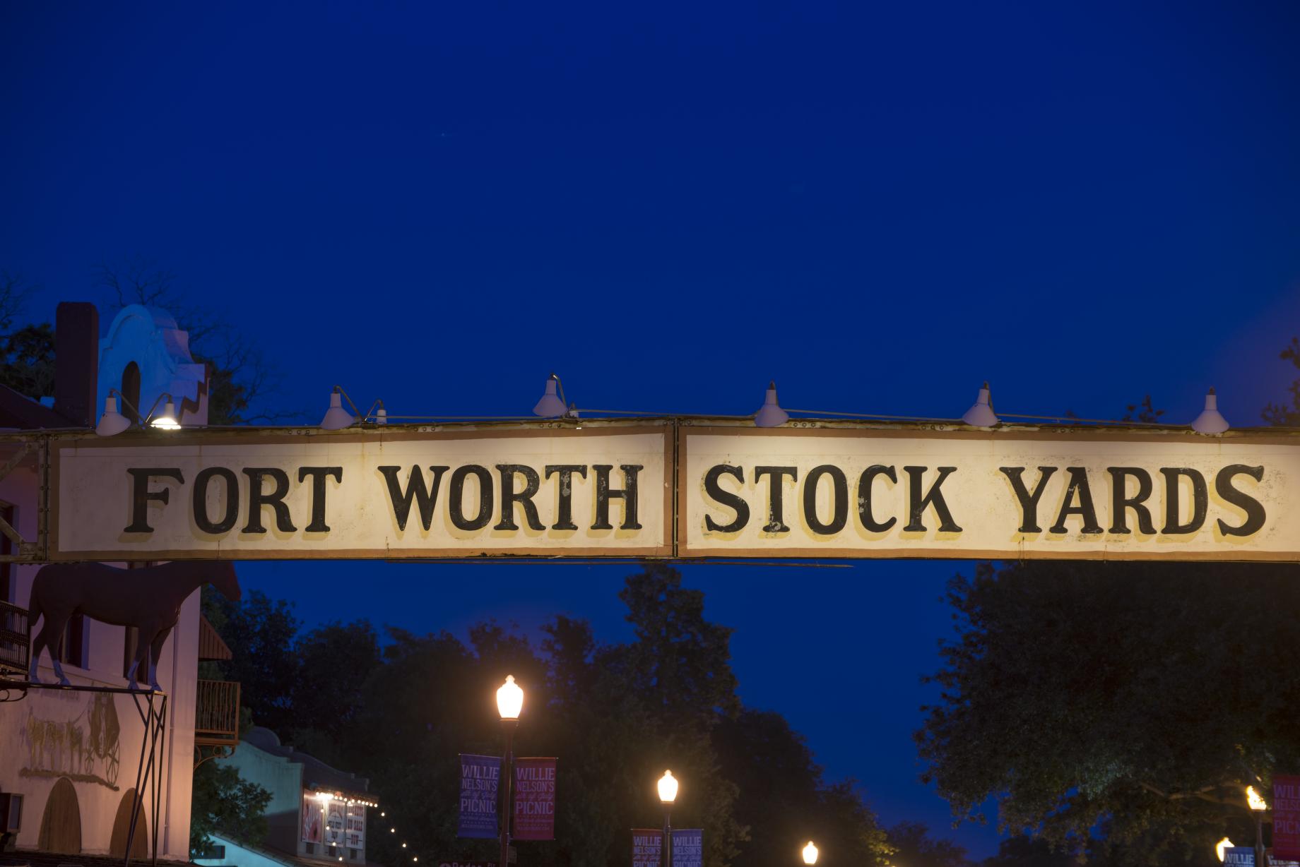 Illuminated sign above Exchange Avenue in the Stockyards District of Fort Worth, Texas